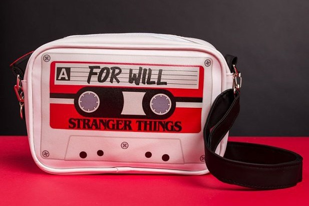 Cassette-style crossbody bag on a red table