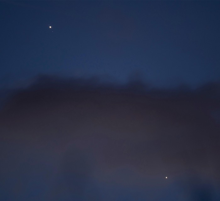Blue night sky with cloud and glowing planets
