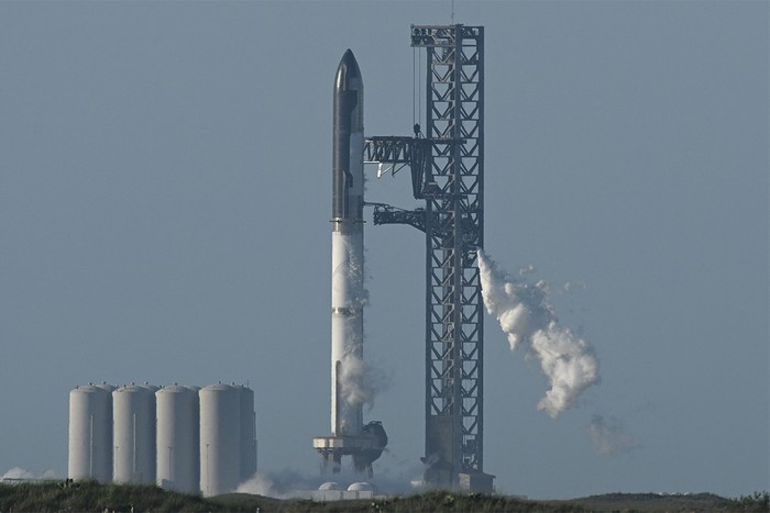 Rocket on launchpad with smoke plumes